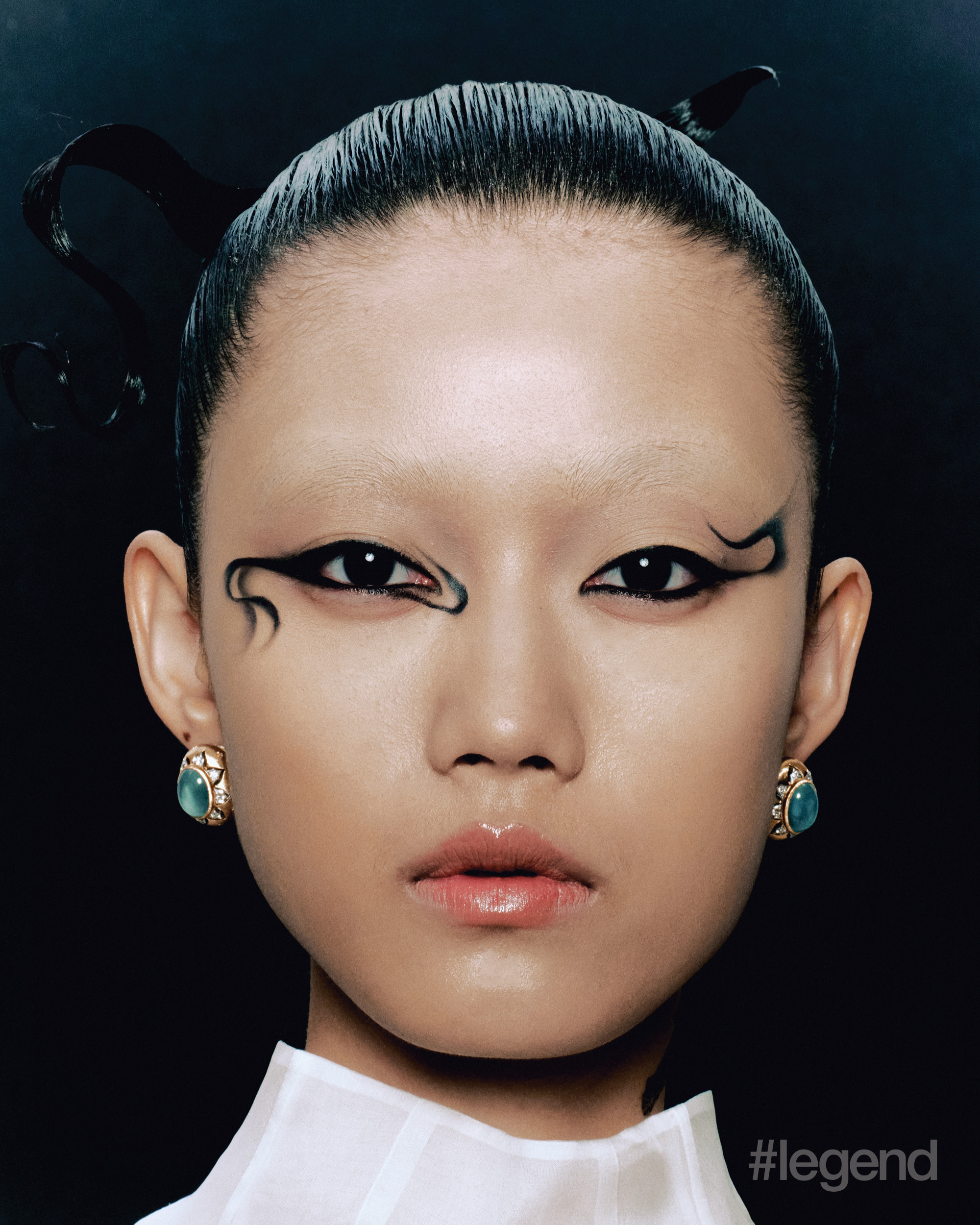 White high-neck top _ Fendi; Macri Colour Collection earrings in yellow and white gold with aquamarine and diamonds _ Buccellati