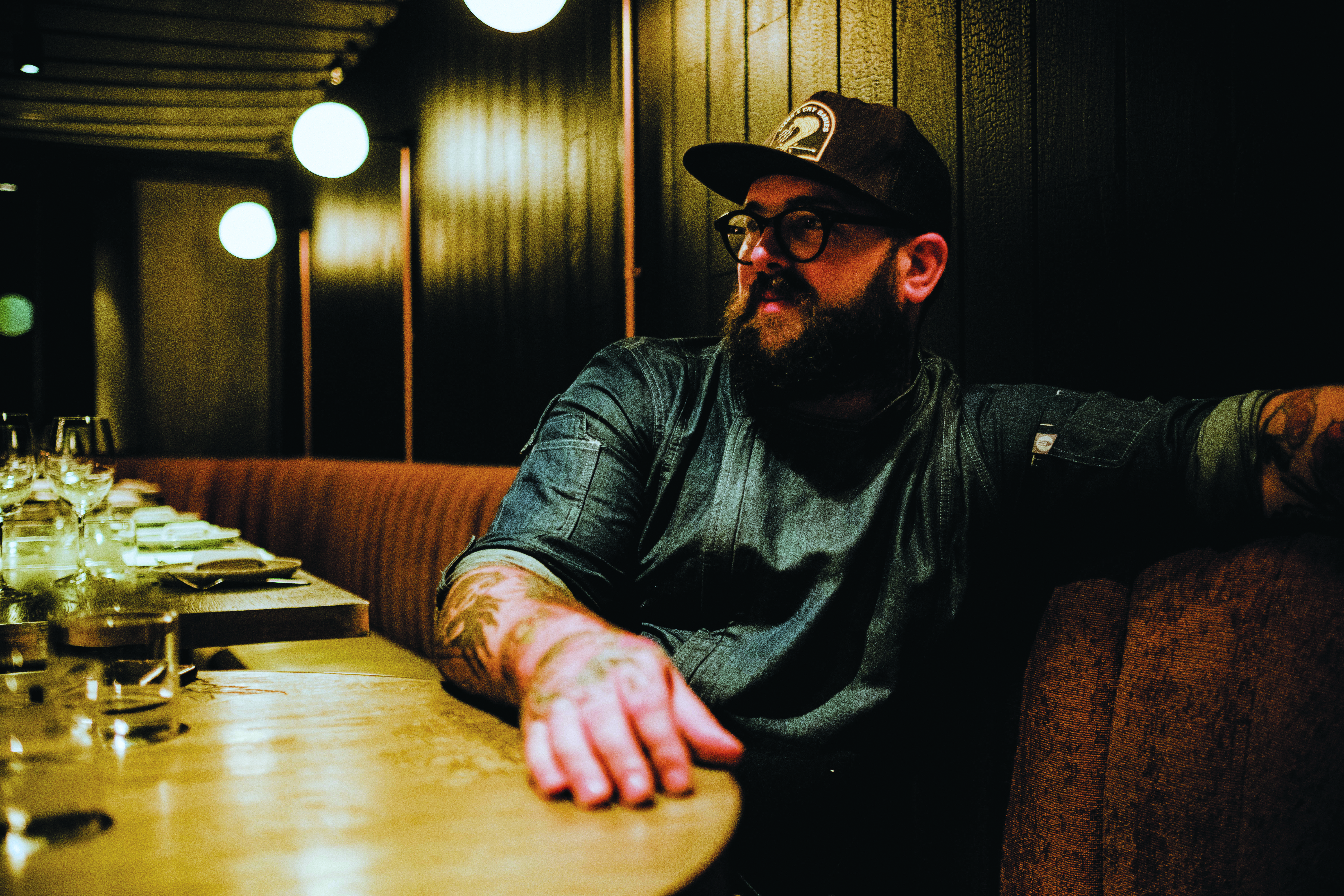Chef and owner Nate Green relaxes at a booth in Rhoda before its closure in September