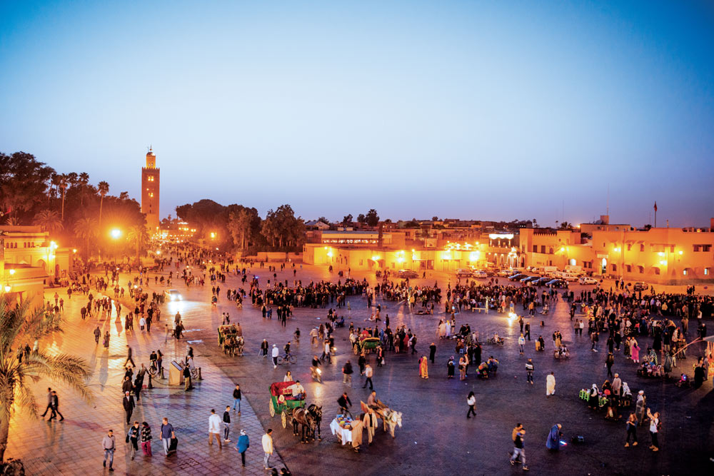 People gather at the Jemaa el Fnaa square at dusk. Photo by Getty Images