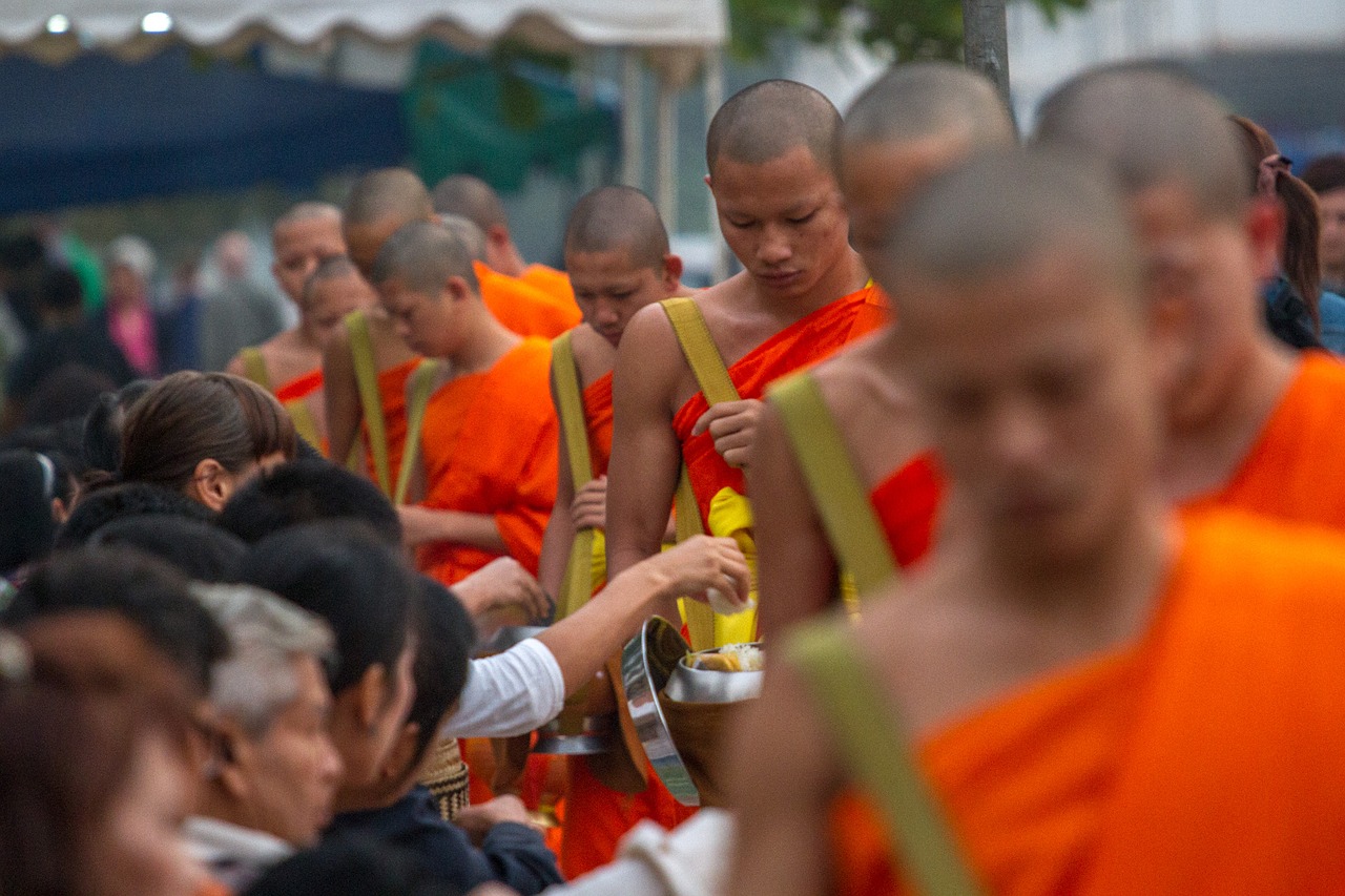 Young monks collect their morning alms 